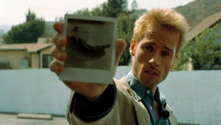 Guy Pearce acting in the role of vengeful amnesiac Leonard Shelyby in the neo-noir film Memento directed by Christopher Nolan